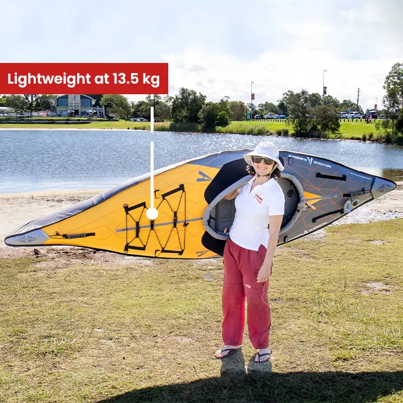 AdvancedFrame Elite Kayak lifted by a woman showcasing lightweightness